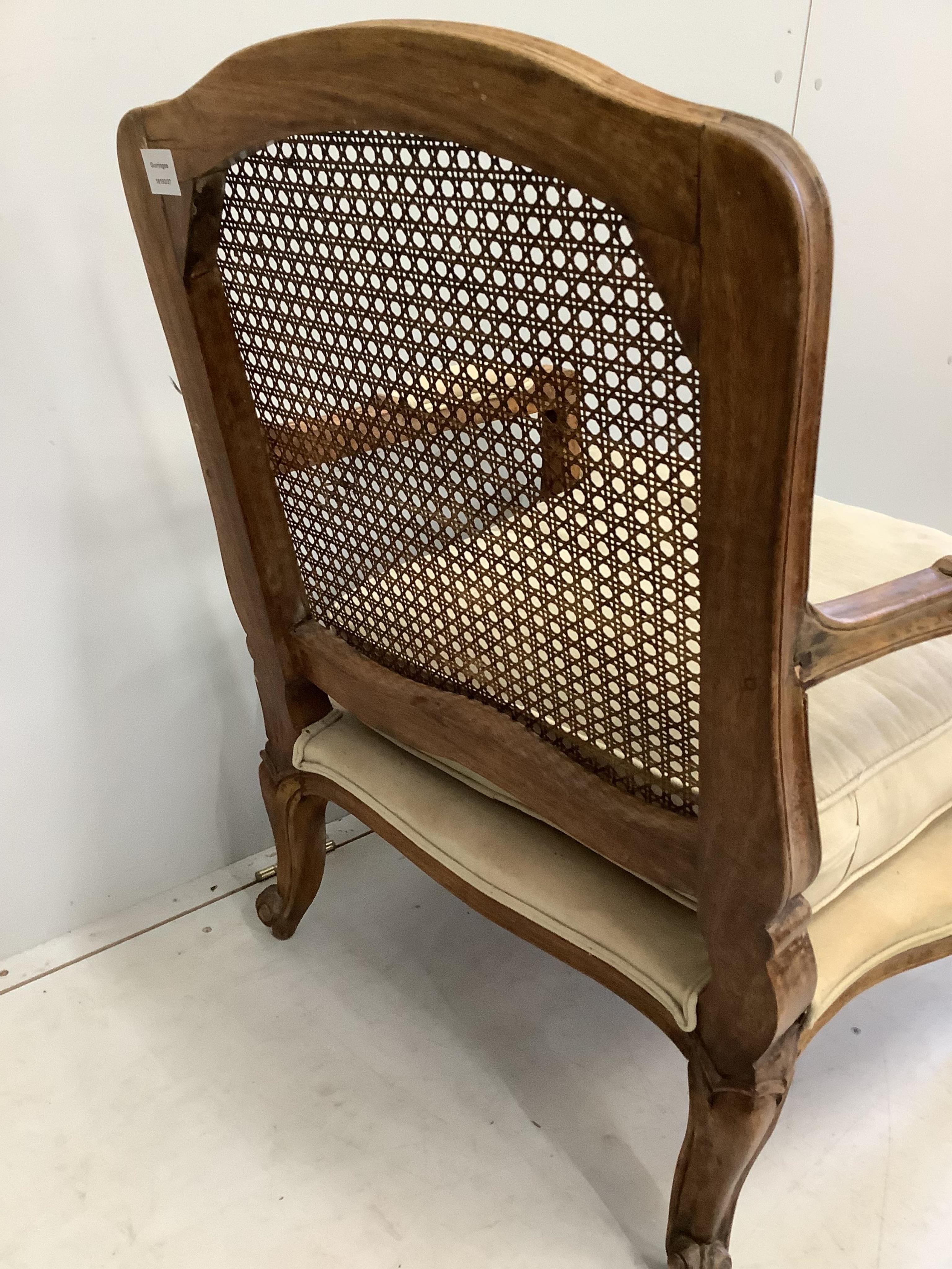 A Louis XVI style caned back beech armchair, width 64cm, depth 64cm, height 87cm